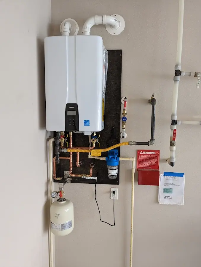 Professional plumber installing copper piping in a Williston Highlands home